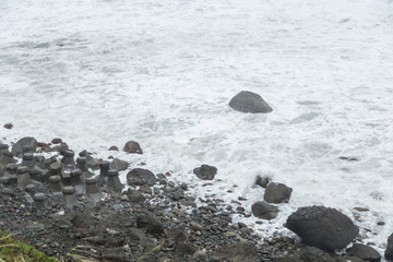 Stormy sea with waves crashing on rocks