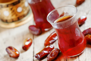 Two cups of black tea  in traditional Islamic cups with sweet da