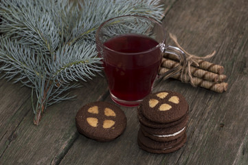 the transparent mug of red tea decorated with a fir-tree branch