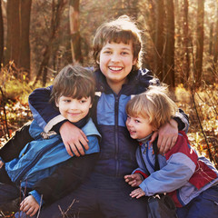 Naklejka premium three happy boys in autumn forest