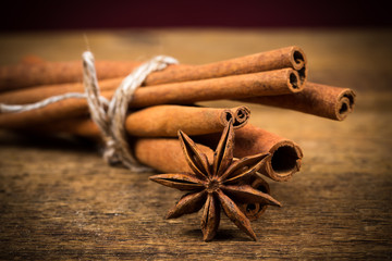 Close up of cinnamon sticks and star anise on wood