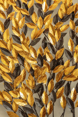 Close up Gold and black artificial leaf on wall