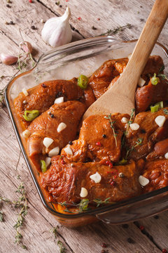 Raw meat in a spicy red marinade in a bowl close up. Vertical
