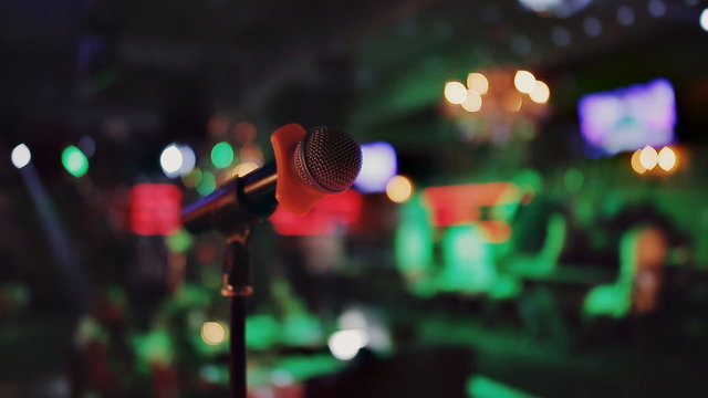 the microphone at a karaoke bar