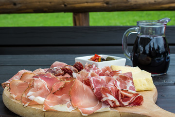 typical Italian appetizer with salami, cheese and pickles