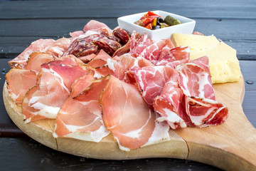 typical Italian appetizer with salami, cheese and pickles