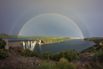 Rainbow after a heavy rain above Sibenik bridge and the channel of river Krka