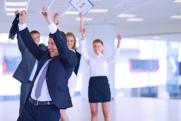 Business team celebrating a triumph with arms up 