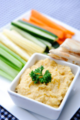 Healthy dip humus and raw vegetable sticks