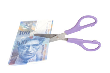 One hundred swiss franc banknotes with scissors.currency of swit