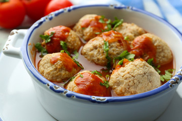 Meat balls with tomato sauce, on wooden background