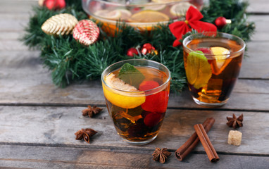 Sangria in bowl and glasses with Christmas decoration on wooden table close up