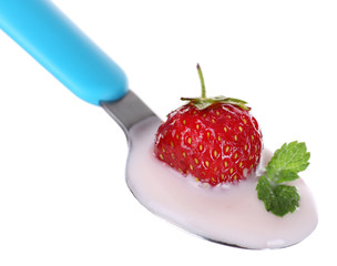 Delicious yogurt in spoon with strawberry and mint isolated on white