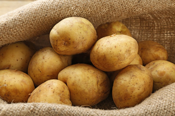 Young potatoes on sackcloth close up