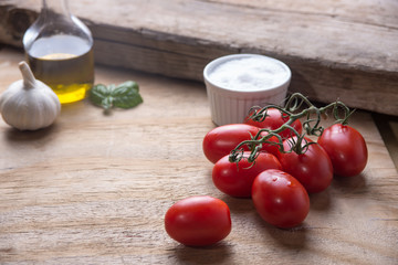 Ingredients for a typical italian lunch lying on a wooden table