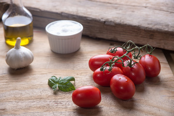 Ingredients for a typical italian lunch lying on a wooden table