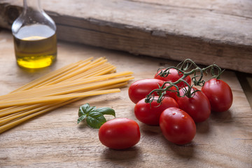 Ingredients for a typical italian lunch lying on a wooden table