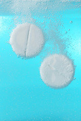 Effervescent painkiller tablets in water, closeup