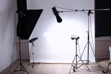 Empty photo studio with lighting equipment