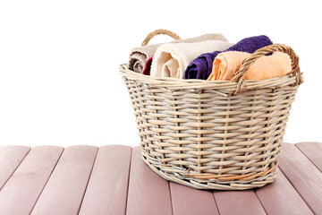 Colorful towels in basket isolated on white