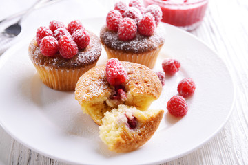 Delicious cupcakes with berries on plate close up