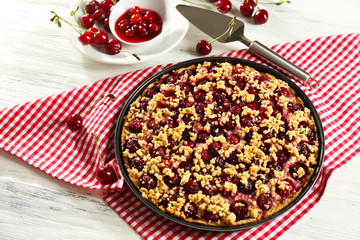 Tasty homemade pie with cherries on table close up