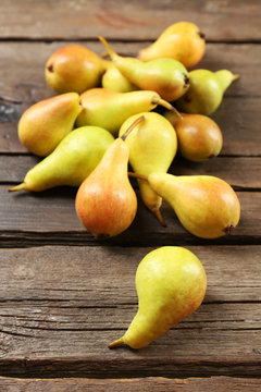 Ripe pears on wooden table close up