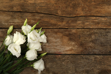 Beautiful eustoma on wooden background