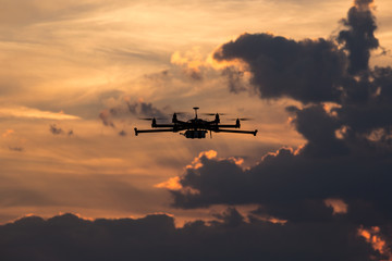 Professional drone flying on the cloudy dark sky