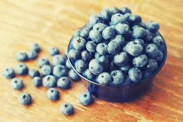 blueberries in plate, wooden background