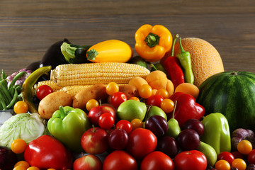 Heap of fresh fruits and vegetables on table close up