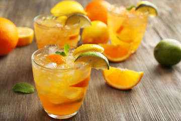 Glasses of orange juice on wooden table, closeup