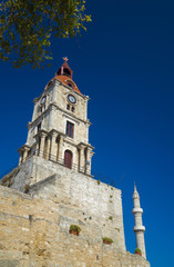 Fototapeta na wymiar Clock tower and mosque minaret of old Rhodes
