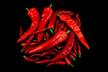 Small and Large Chilli Peppers on a Black Background