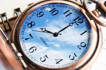 Vintage Clock face in blue sky