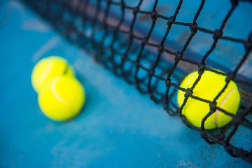 Foto op Canvas tennis ball on a tennis court with net © Sunanta