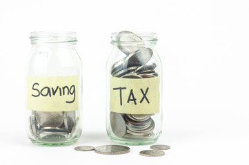Jar for savings and taxes full of coins.