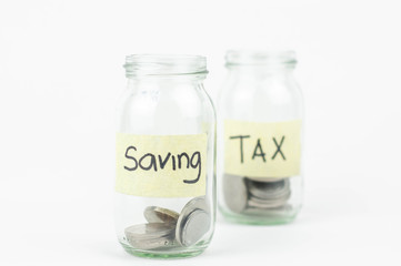 Jar for savings and taxes full of coins.