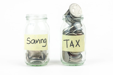 Jar for savings and taxes full of coins.