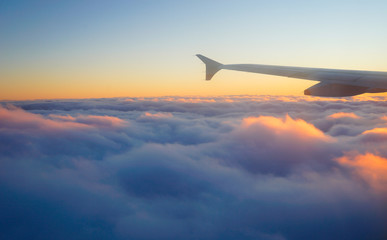 Airplane Wing in Flight from window, sunset sky