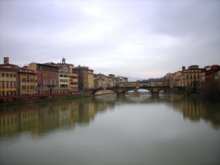 Fototapeta na wymiar Beautiful renaissance architecture of Florence on the banks of river Arno on a clody day. Italy, Tuscany.