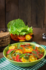 Summer tomato salad with basil, pesto and arugula