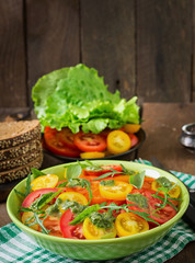 Summer tomato salad with basil, pesto and arugula