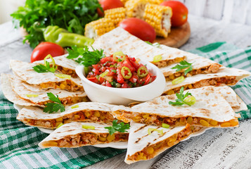 Mexican Quesadilla wrap with chicken, corn and sweet pepper and salsa.