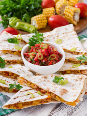 Mexican Quesadilla wrap with chicken, corn and sweet pepper and salsa.