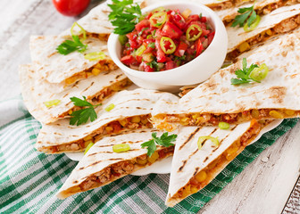 Mexican Quesadilla wrap with chicken, corn and sweet pepper and salsa.