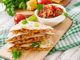 Mexican Quesadilla wrap with chicken, corn and sweet pepper and salsa.