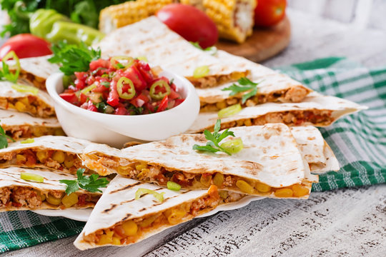 Mexican Quesadilla wrap with chicken, corn and sweet pepper and salsa.