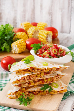 Mexican Quesadilla wrap with chicken, corn and sweet pepper and salsa.