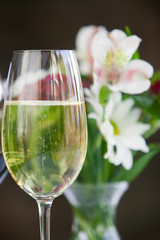 Glass of white wine with flowers.